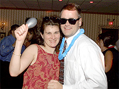 Couple dancing with party props at DJ wedding